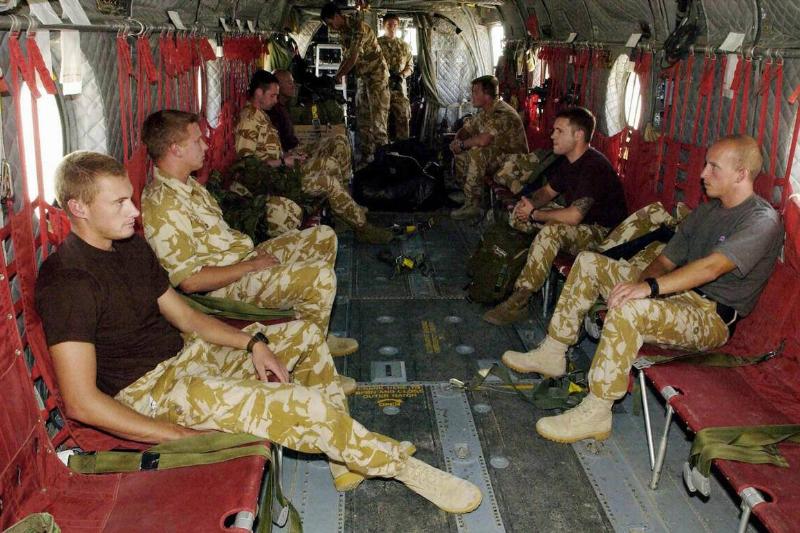 British servicemen sit onboard a militar
