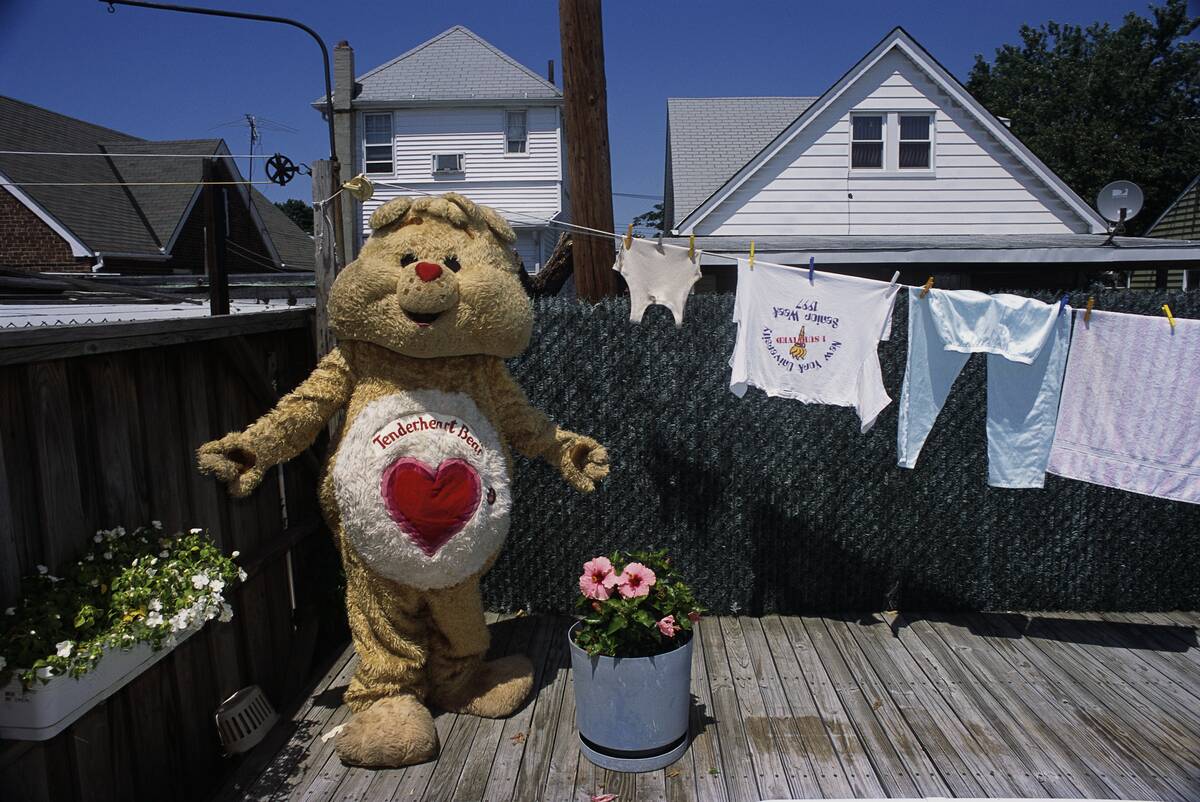 Richard Concepcion Wearing Bear Costume Near Clothesline