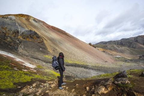 A young woman on the red mountain of the 54 km trek from Landmannalaugar, Iceland.