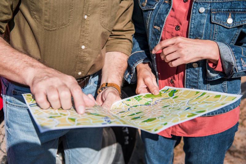 Two hikers holding a map. 