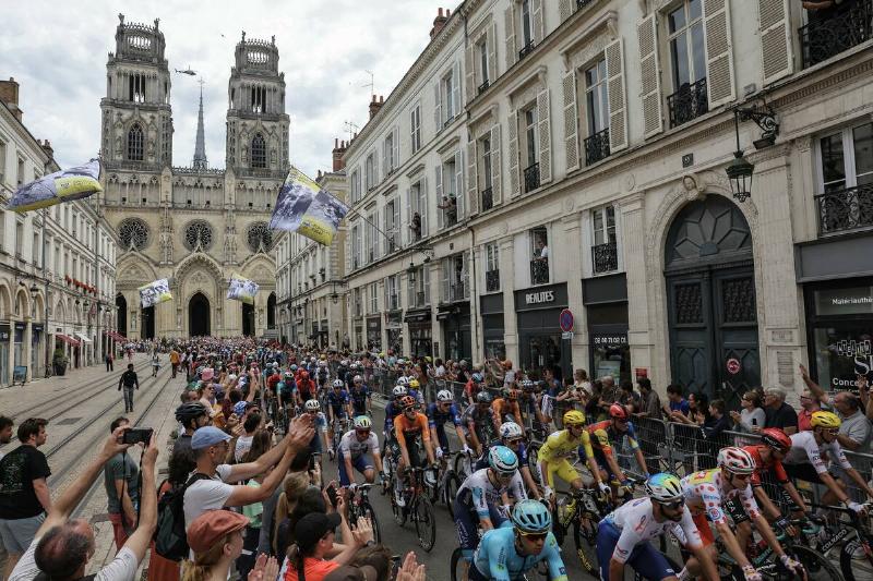 The pack of riders (peloton) cycle at the start of the 10th stage of the 111th edition of the Tour de France cycling race, 187,3 km between Orleans and Saint-Amand-Montrond, central France, on July 9, 2024.