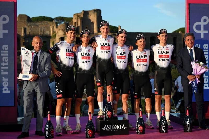 Igor Arrieta of Spain, Filippo Baroncini of Italy, second place winner - Isaac Del Toro of Mexico, Rafal Majka of Poland, Brandon McNulty of The United States, Jay Vine of Australia, Adam Yates of Great Britain and Team UAE Team Emirates - XRG celebrate at podium as best team during the 108th Giro d'Italia 2025, Stage 21. 
