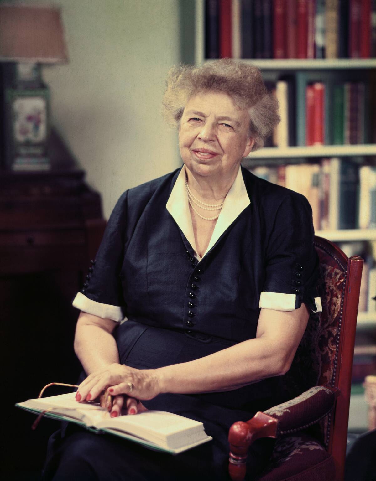 Eleanor Roosevelt Smiling with Book in her Lap