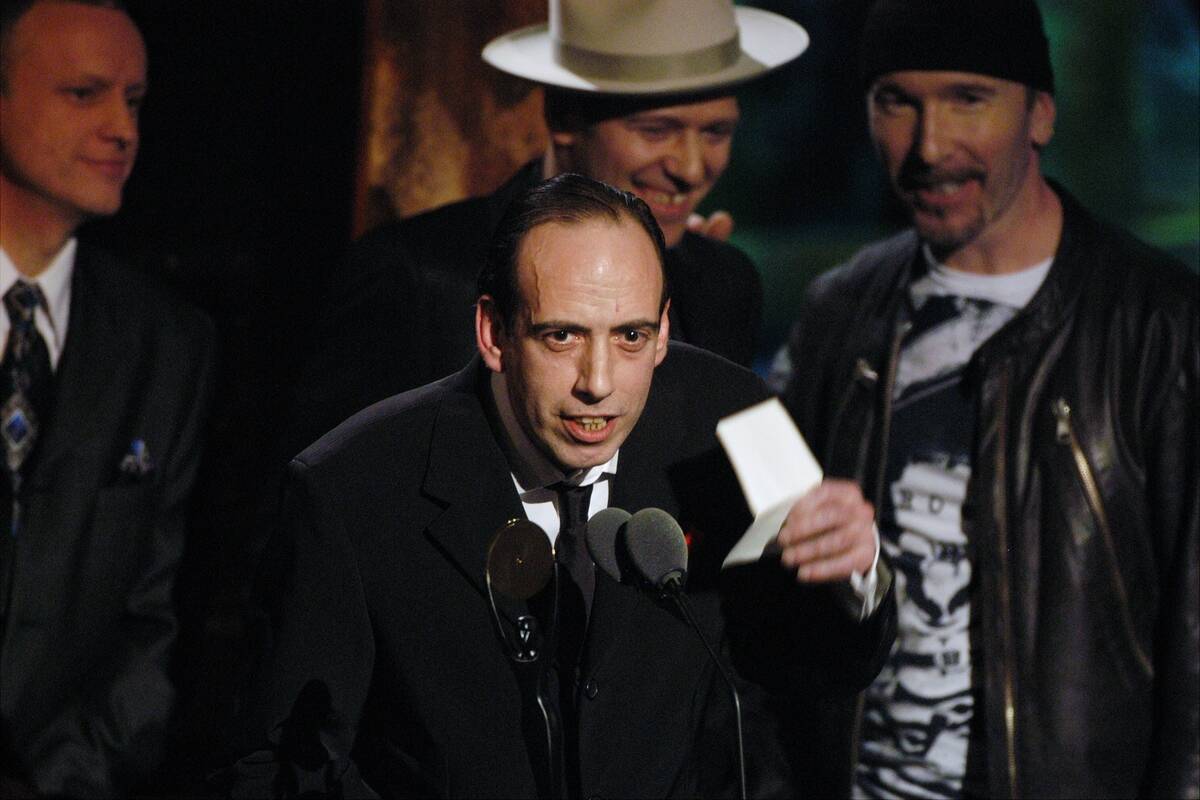 Mick Jones speaks as his group The Clash is inducted into th