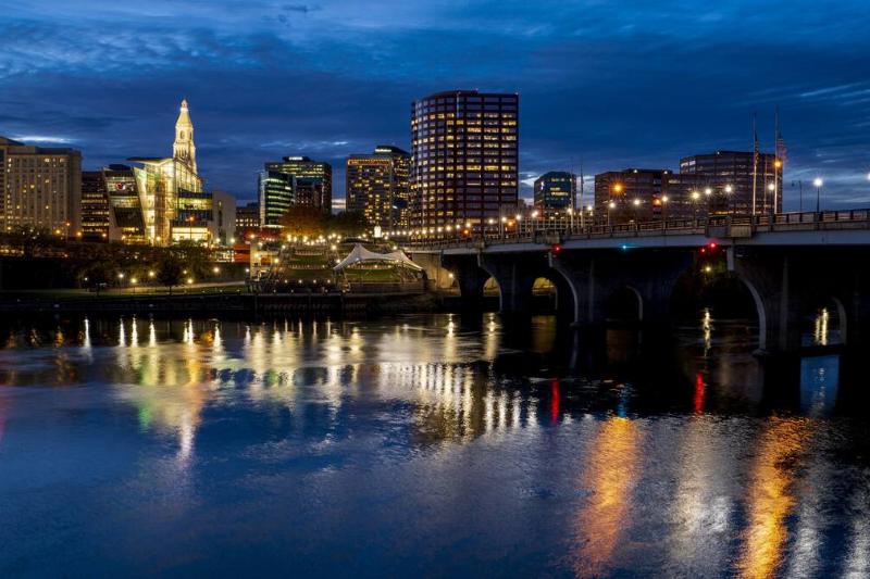 Skyline view of Hartford on Connecticut River with lights coming on, Connecticut