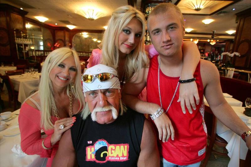 Terry (Hulk) Hogan sits surrounded by (l. to r.) wife Linda,