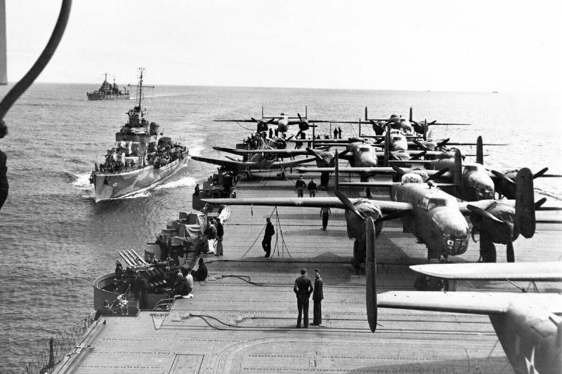 USA/Japan: Some of the B-25 Mitchell Bombers of the Doolittle Raiders crowd the rear deck of the USS Hornet with two escort vessels following close in the background, north Pacific, April 1942