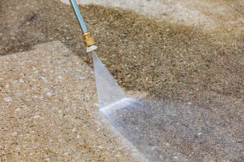 Pressure washer cleaning stain.