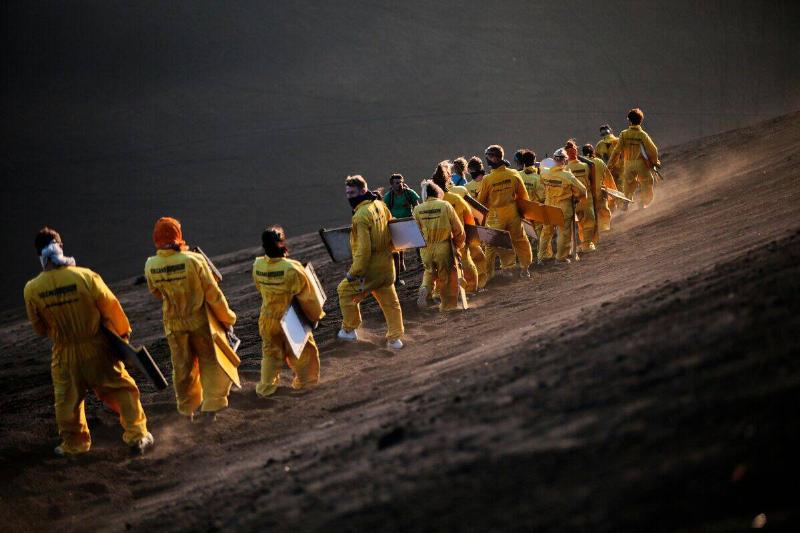 Tourists prepare to slide down the slopes of the Cerro Negro volcano