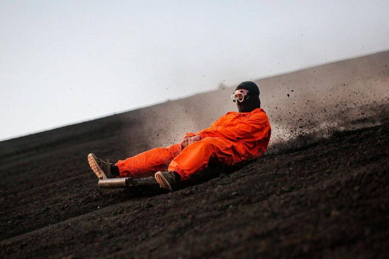 A tourist slides down the slopes of the Cerro Negro volcano.