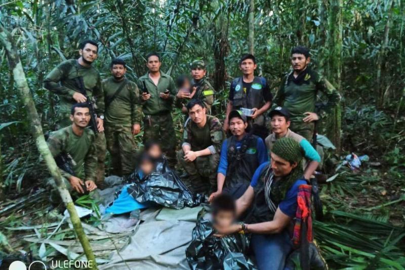 Colombian Military Forces pose for a photo as they found four children who survived 40 days in the Amazon jungle.
