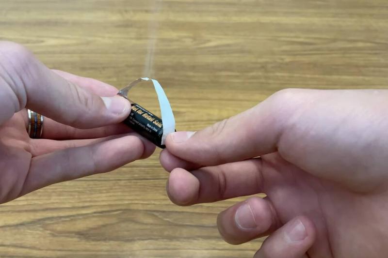 Battery and gum wrapper. 