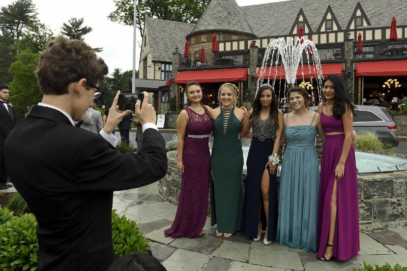 A group of girls pose in front of the fountain for pictures.Wyomissing High School 2017 prom held at the Reading Country Club. Photo by Jeremy Drey 5/28/2017