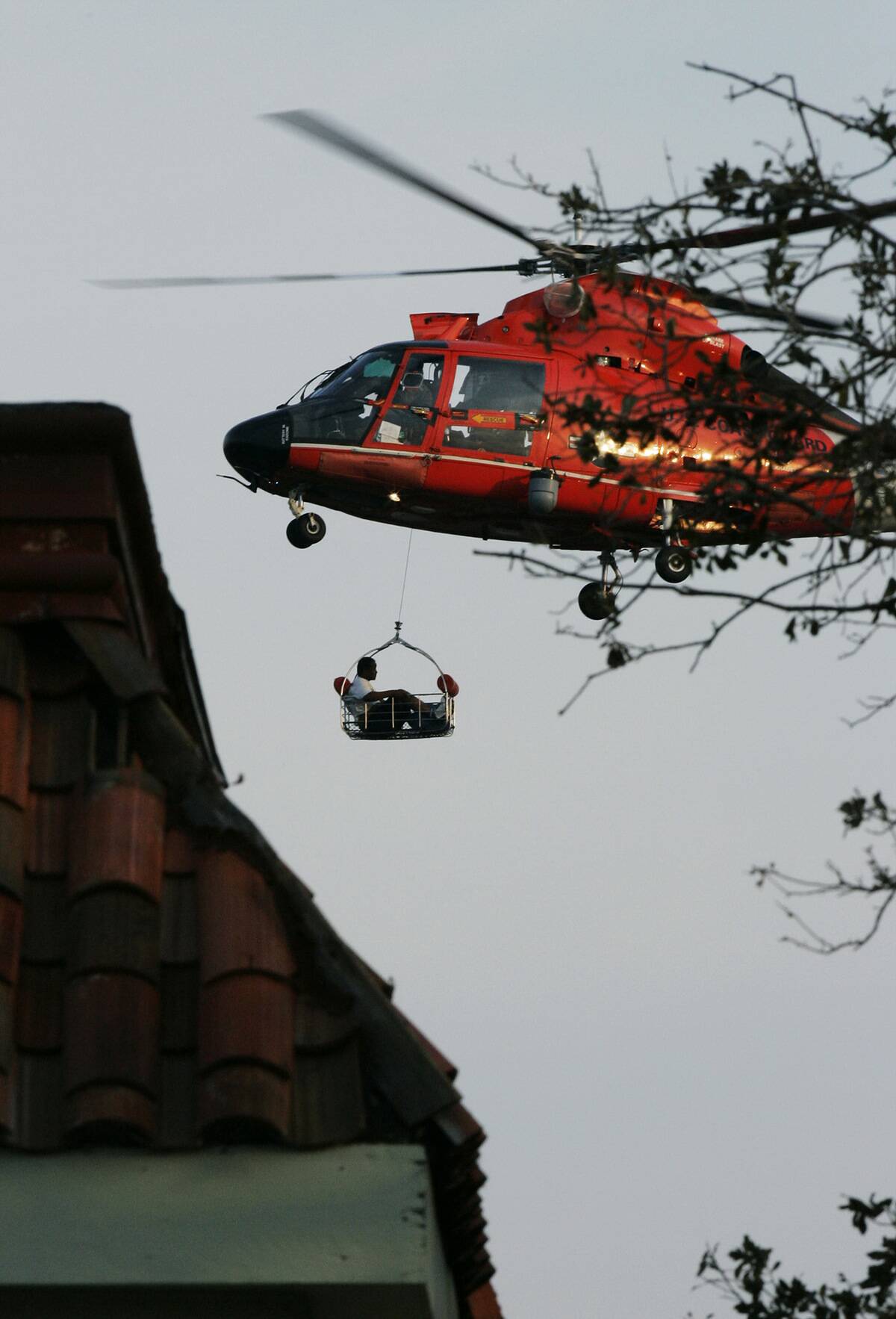A man is airlifted from his home by a helicopter in New Orle