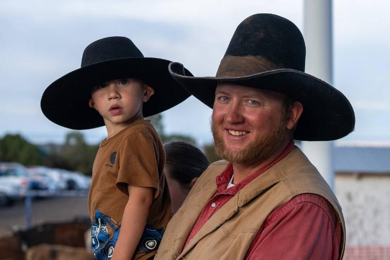 A rancher and his young son attend a rodeo in a small town in rural Utah