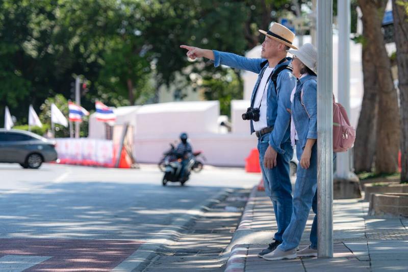 A couple walks around the street in the old city of Bangkok, Thailand.