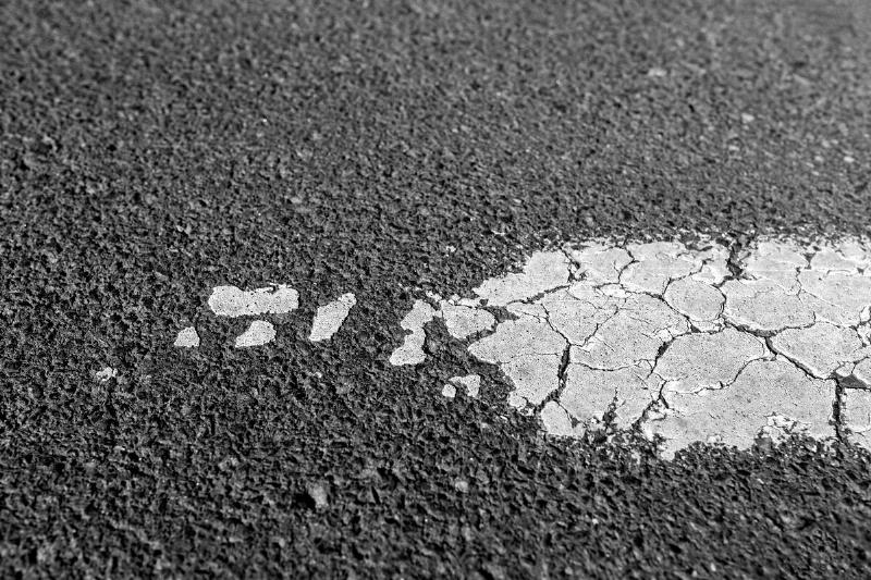 Chipped paint on asphalt. 