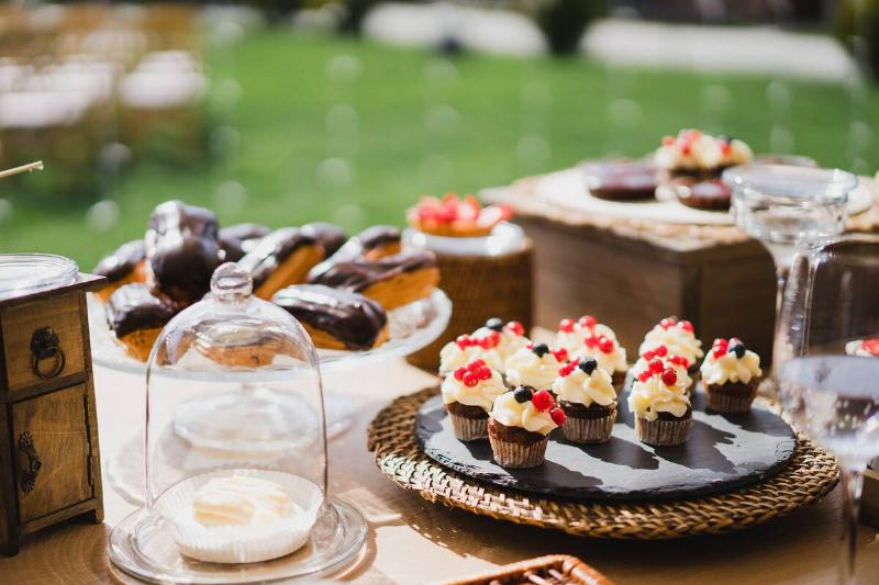 Candy bar with tasty desserts and appetizers at wedding reception.