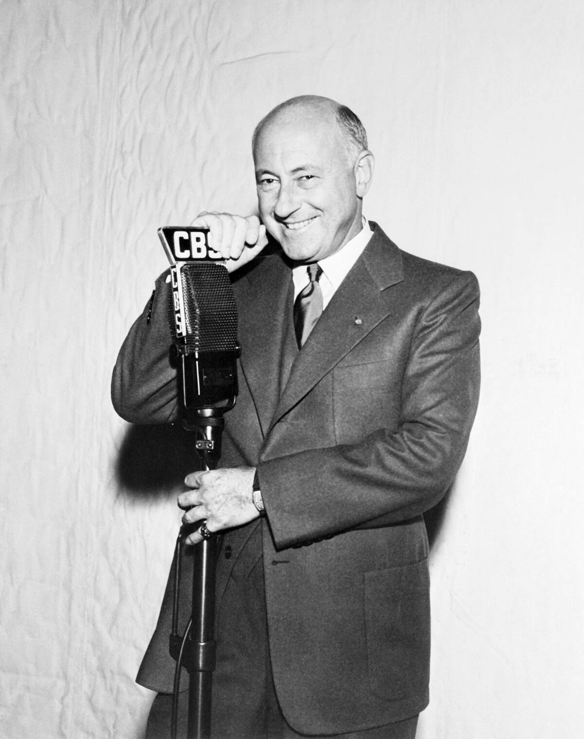 Cecil B. DeMille Standing at Microphone