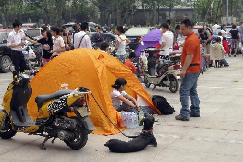 Chinese residents camp out with their do