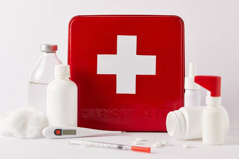 Red first aid kit and medical supplies.