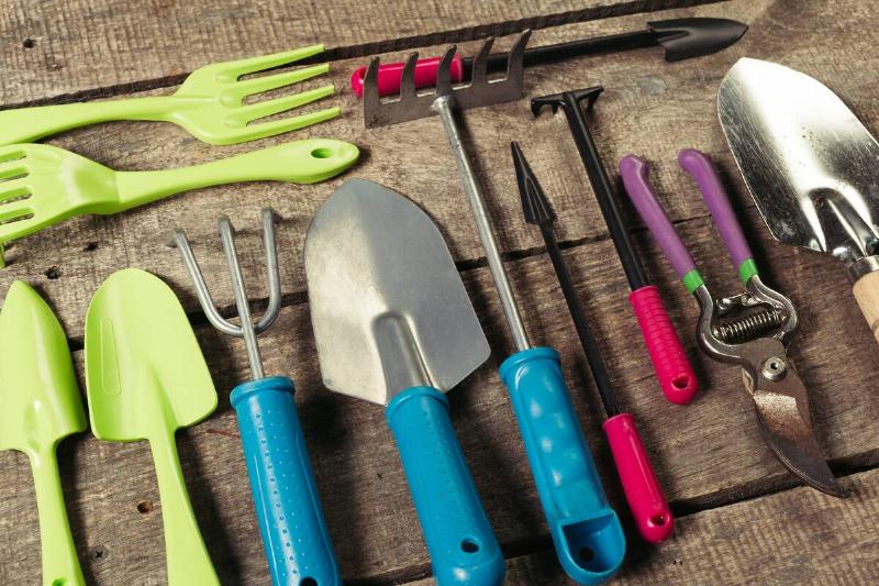 Garden tools on wooden bench. 