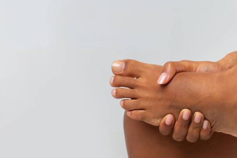 Person holding foot.