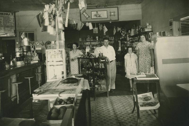 Family posing in mom and pop restaurant.