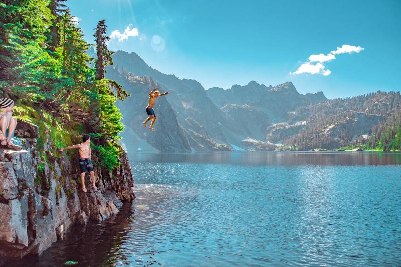Group of friends jumping of a cliff. 