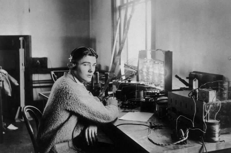 Herbert Hoover, Jr., at a radio set, who later made the national broadcast of the Zeppelin's flight over Los Angeles. (H