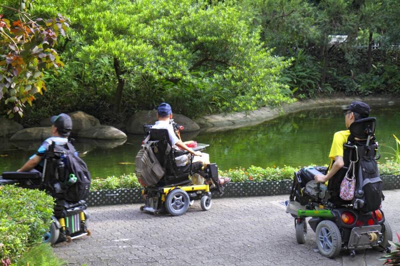 Hong Kong Park, Asian man in electric wheelchair