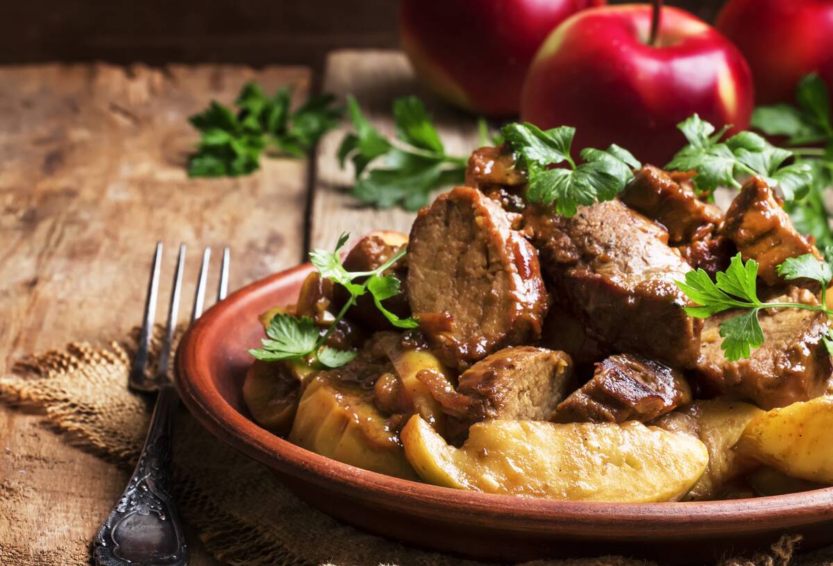 Apple and pork skillet on a plate. 