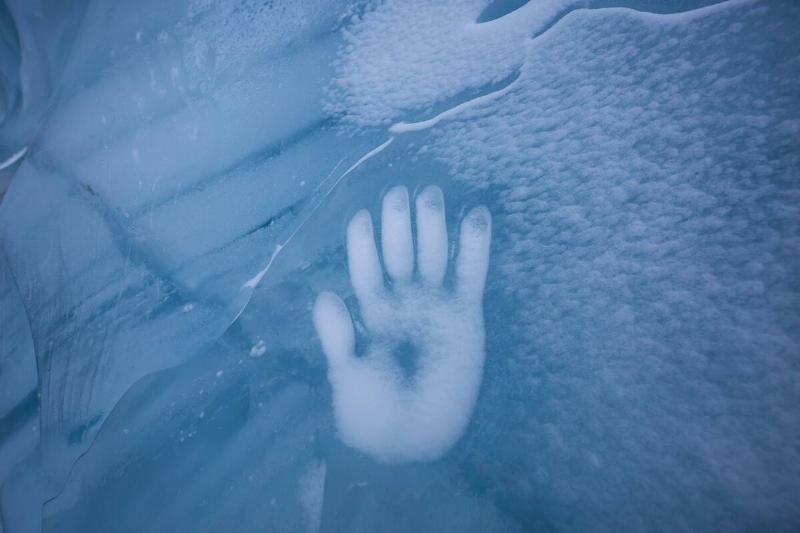Human Hand Imprint on the Ice Wall in the Natural Cave during winter.