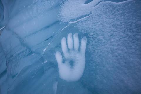 Human Hand Imprint on the Ice Wall in the Natural Cave during winter.