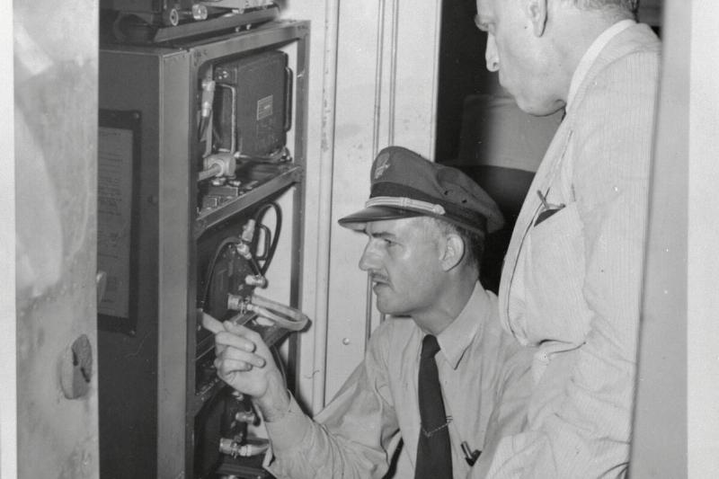 Jack Le Claire and James M Landis Inspecting Airplane Radar