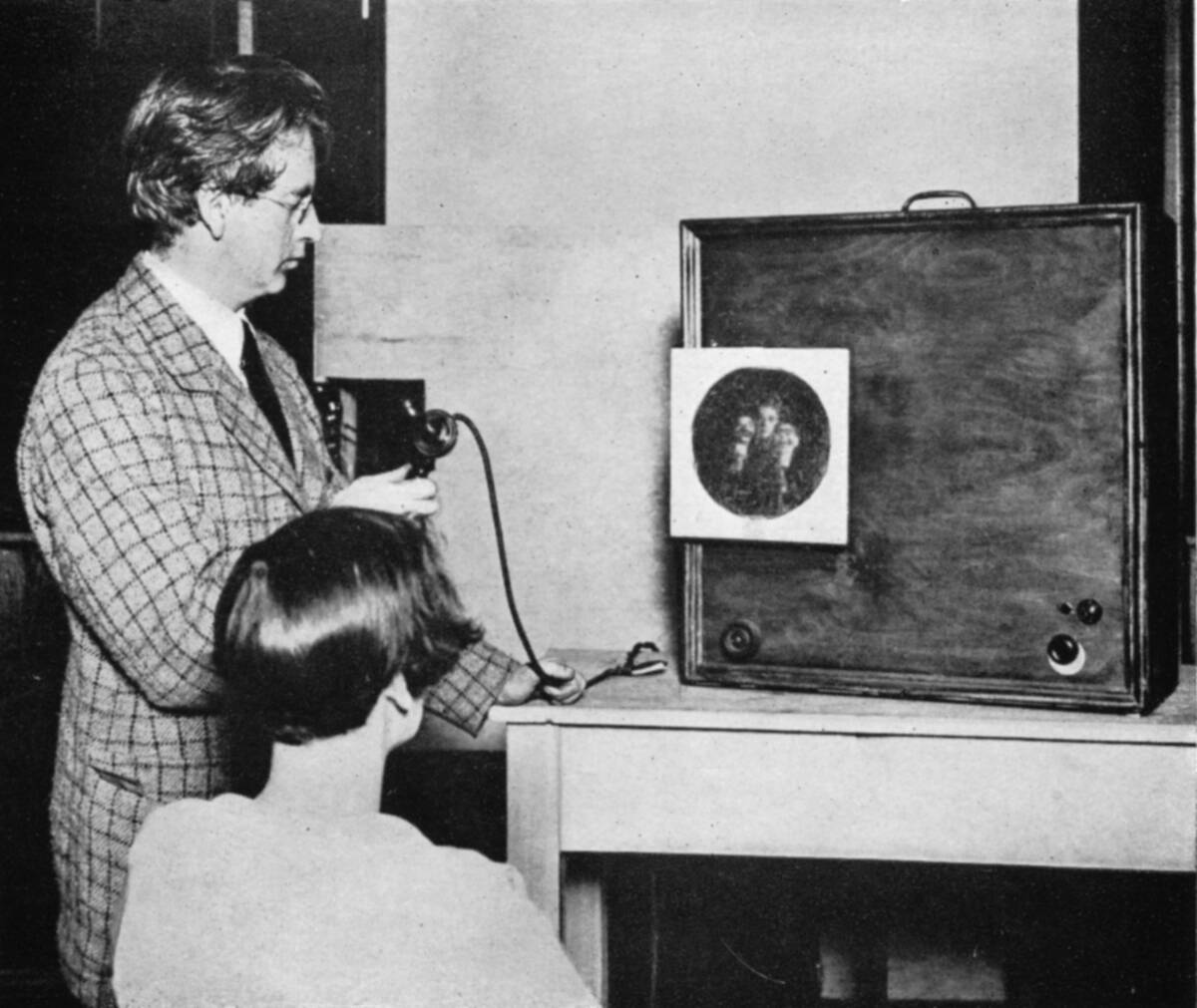 John Logie Baird (1888-1946) Scottish electrical engineer: pioneer of television. Baird in front of an early television ('Seeing by wireless') transmitter...