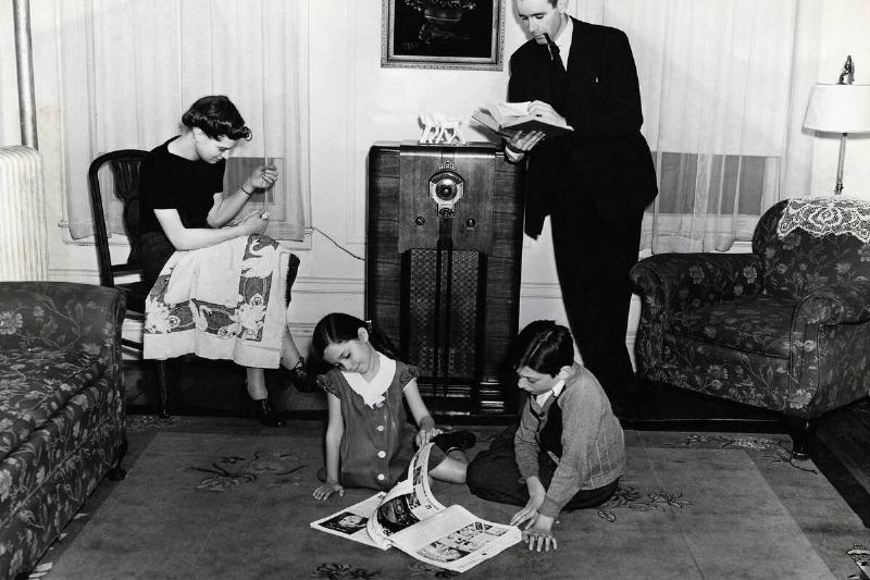Living Room Scene With a Family Listening to the Radio