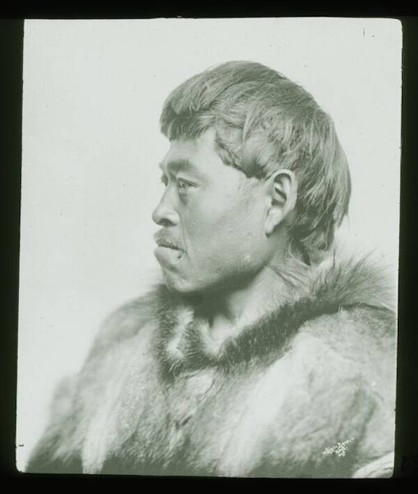Black and white profile lantern slide of a Inuit man in a parka described as a 