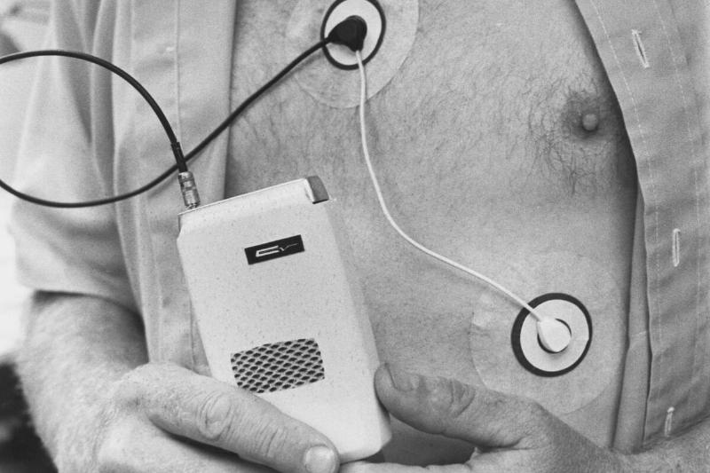 Man Attached and Holding to Medical Device