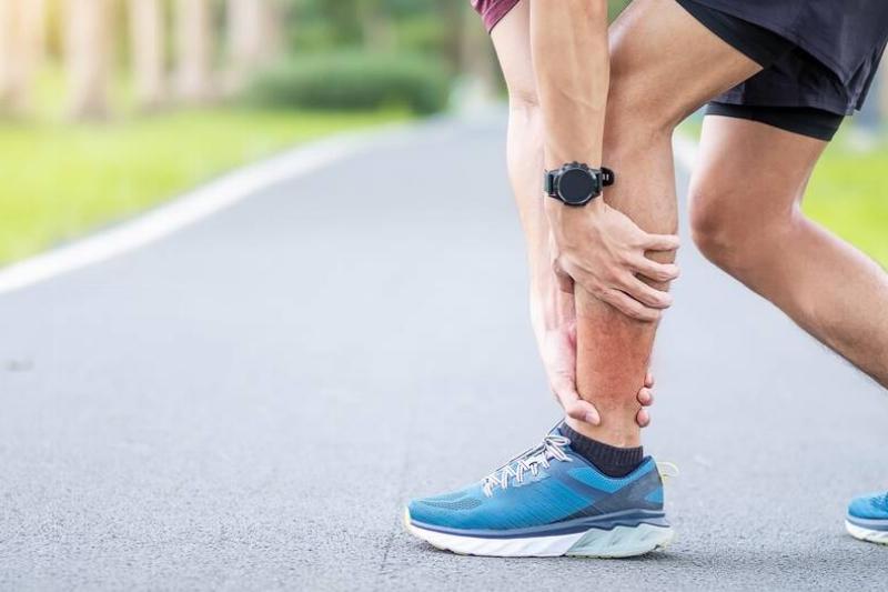 Hands holding shins. 