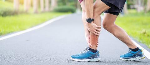 Hands holding shins. 