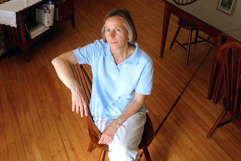 Mary Roy poses in the Haskell Free Library, which straddles