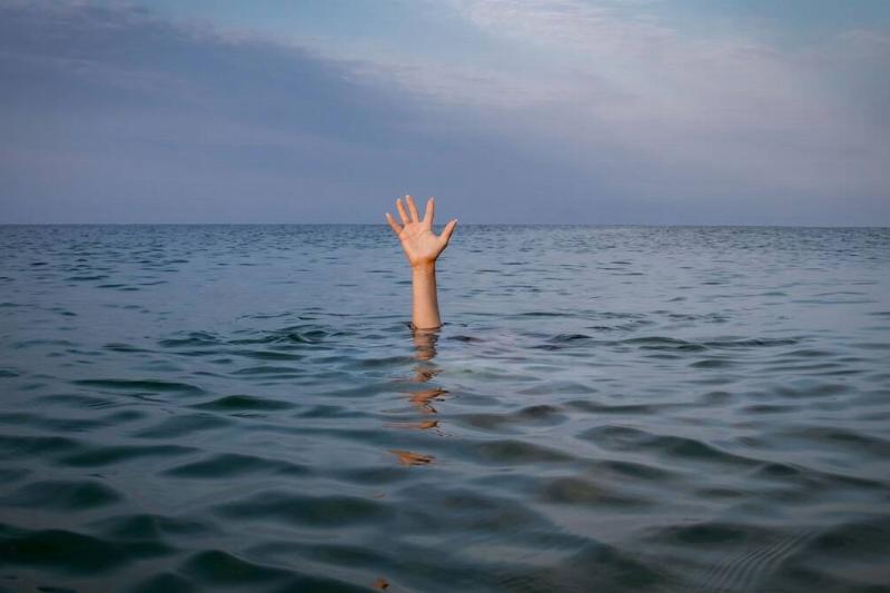 Hand reaching out of water. 