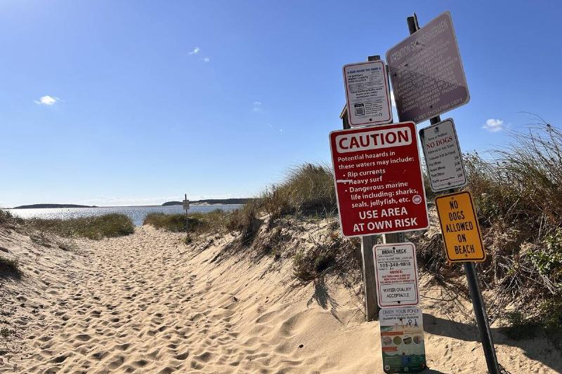 Multiple warning signs and rules at entrance to beach at Indian Neck, Wellfleet, Cape Cod, Massachusetts