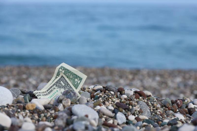One dollar bill at the beach.