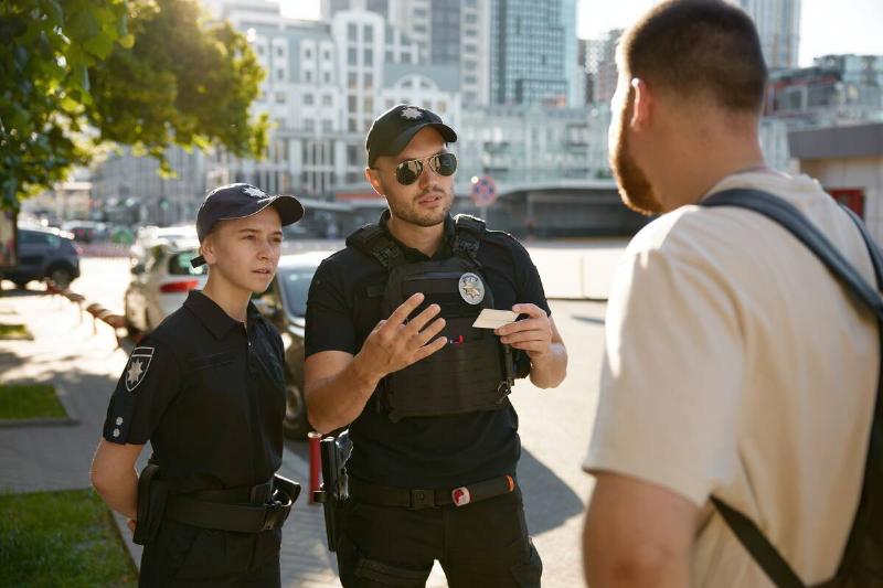 Patrol policeman and policewoman talking to someone.