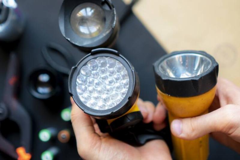 Hands holding flashlight.