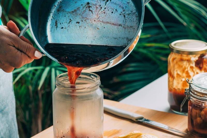 Pouring sauce into jar. 