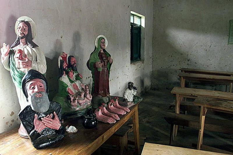 Religious statues ornament a table 19 March 2000 i