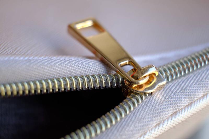 Golden zipper of white fabric.